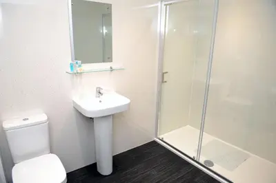 a bathroom with a toilet and a sink and a shower at Premier Lodge in Falkirk