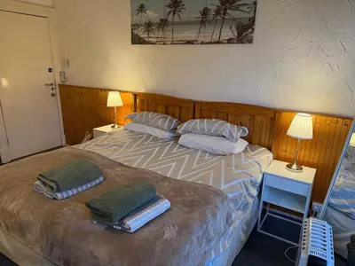 a bedroom with a bed with two pillows on it at Glades House in Glasgow
