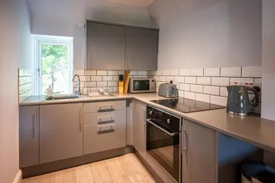 a kitchen with stainless steel appliances and a sink at One Oban in Oban