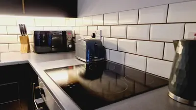 a kitchen with a counter top with a toaster and a sink at One Oban in Oban