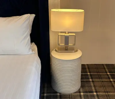 a lamp sitting on a table next to a bed at The Valentine - Townhouse Hotel - Adults Only in Edinburgh