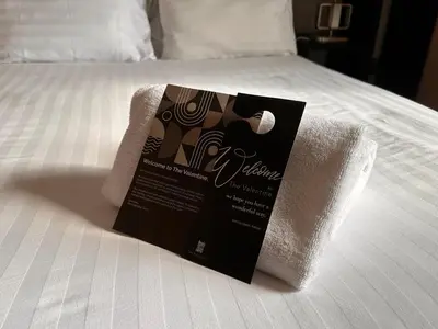 a package of towels sitting on a bed at The Valentine - Townhouse Hotel - Adults Only in Edinburgh
