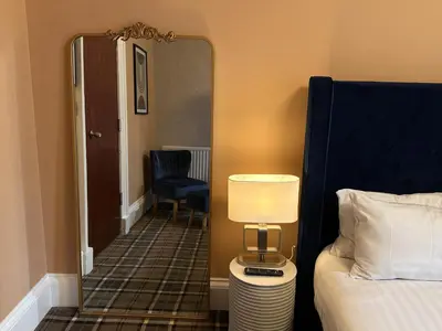 a room with a bed and a lamp and a mirror at The Valentine - Townhouse Hotel - Adults Only in Edinburgh