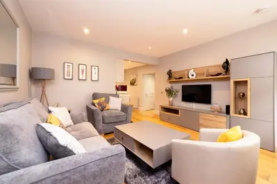 a living room with two couches and a tv at JOIVY Splendid Flat near Edinburgh Castle in Edinburgh