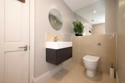a bathroom with a toilet and a sink and a mirror at JOIVY Splendid Flat near Edinburgh Castle in Edinburgh