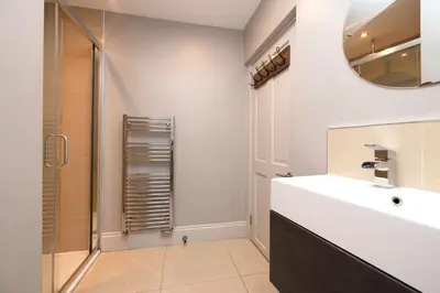 a bathroom with a sink and a shower at JOIVY Splendid Flat near Edinburgh Castle in Edinburgh
