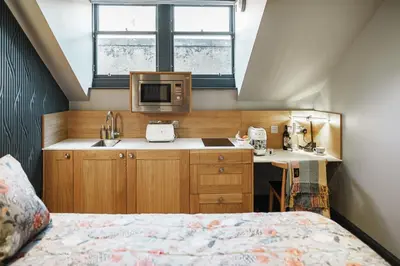 a small kitchen with a bed in a room at Bonnie Hotel - Smart Boutique ApartHotel - Haymarket Edinburgh in Edinburgh