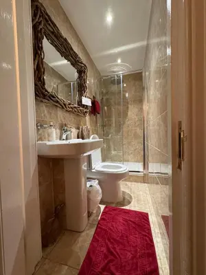 a bathroom with a sink and a toilet and a shower at The West Highland Way Hotel and Retreat Accommodation in Glasgow