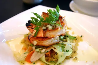 a plate of food with shrimp on top of rice at Loch Leven Hotel & Distillery in Glencoe