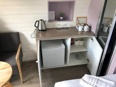 a desk in a tiny kitchen with a table at Loch Leven Hotel & Distillery in Glencoe