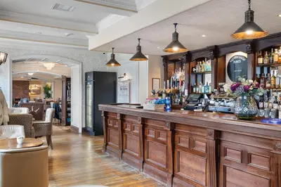 a bar in a restaurant with a counter at The Royal Hotel Campbeltown in Campbeltown