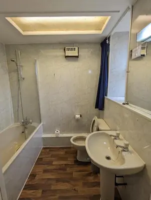 a bathroom with a sink and a toilet and a tub at Eliza House in Edinburgh