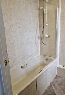 a bathroom with a bath tub with a shower at Eliza House in Edinburgh