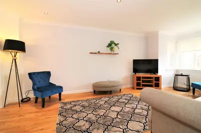 a living room with a couch and a tv at Signature - Morrison House in Glasgow