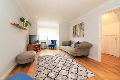 a living room with a couch and a tv at Signature - Morrison House in Glasgow