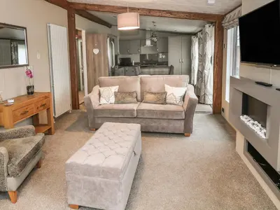 a living room with a couch and a tv at Avonal Lodge 24 in Perth