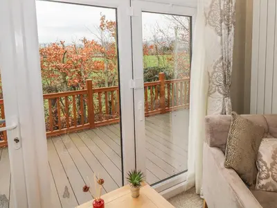 a living room with a sliding glass door to a balcony at Avonal Lodge 24 in Perth