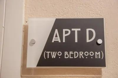 a sign on a wall that says aprid tw two bedroom at Mandarin Premier Apartments D 2 Bed Apt 1st Floor in Oban