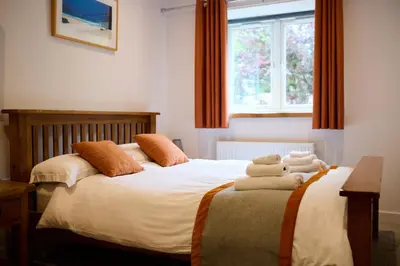two beds in a bedroom with two teddy bears on them at Mandarin Premier Apartments D 2 Bed Apt 1st Floor in Oban