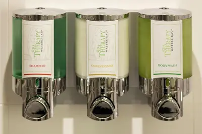 a group of three bottles of wine on a shelf at Hampton By Hilton Hamilton Park in Hamilton