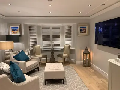 a living room with a couch and a table at Bagpipers Luxury Hideaway Glencoe Ballachulish Highlands Near Fort William in Glencoe