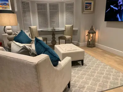 a living room with two couches and a table at Bagpipers Luxury Hideaway Glencoe Ballachulish Highlands Near Fort William in Glencoe