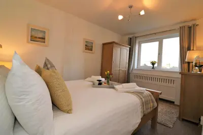 a bedroom with a white bed with pillows and a window at Signature - Gordon House in Glasgow