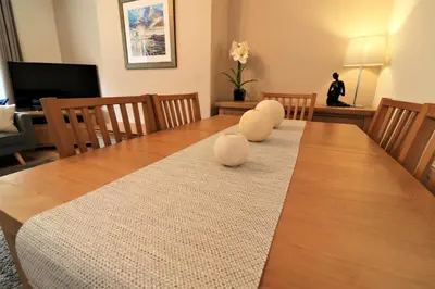 a dining room table with two white balls on it at Signature - Gordon House in Glasgow