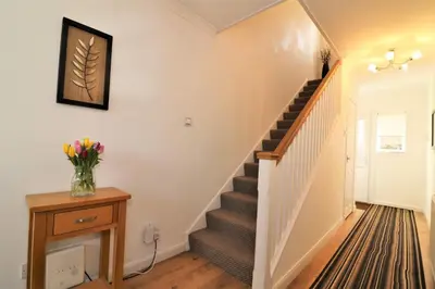 a staircase in a home with a vase of flowers at Signature - Gordon House in Glasgow