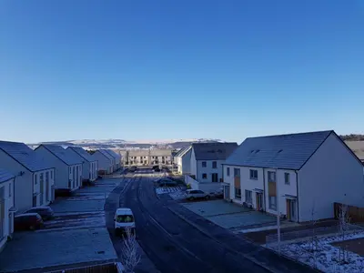 a street with houses and a car on the road at 1 Royal View Apartments in Stirling