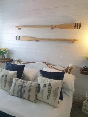 a white bed with pillows on top of it at Boutique Coastal appt nr Edinburgh in Saint Davids