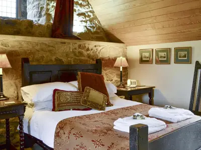 a bedroom with a bed with towels on it at Braidwood Castle - Uk10672 in Braidwood