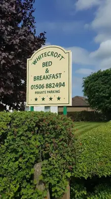 a sign for the millerton bed and breakfast on a field at Whitecroft B&B in Edinburgh
