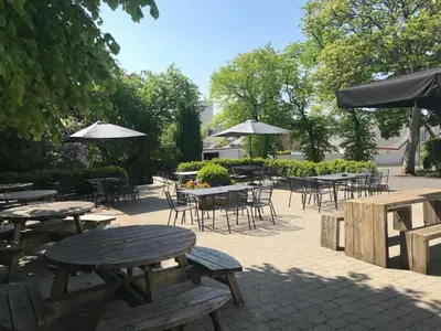 a group of tables and chairs with umbrellas at The Georgian hotel in Coatbridge