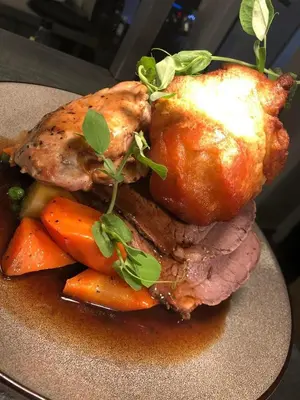 a plate of food with meat and carrots on a table at The Georgian hotel in Coatbridge