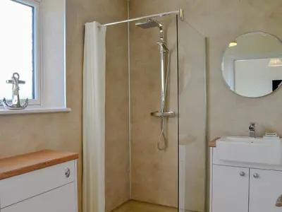 a bathroom with a shower and a sink at Blueacres in Skirling