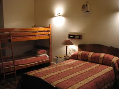 a bedroom with two bunk beds and a lamp at Lancaster Hotel in Oban