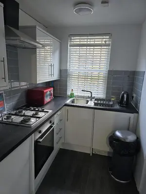 a small kitchen with a sink and a stove at The Residence - NO 57 in Edinburgh