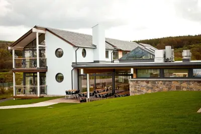 a large white house with a lawn at Portavadie Loch Fyne Scotland in Portavadie