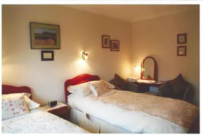 a hotel room with two beds and a mirror at Ashcroft Farmhouse in East Calder