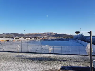 a fence next to a large body of water at 7 Royal View Apartments in Stirling