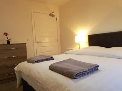 a bedroom with a bed with two towels on it at 9 Royal View Apartment in Stirling