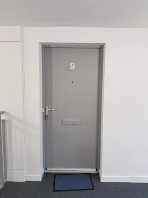 a white door in a white room with a blue rug at 9 Royal View Apartment in Stirling