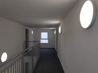 a hallway of a building with two windows at 9 Royal View Apartment in Stirling