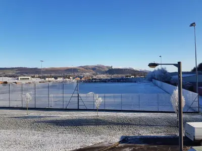 a fence with a view of a body of water at 9 Royal View Apartment in Stirling