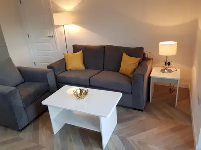 a living room with a couch and a table at 9 Royal View Apartment in Stirling