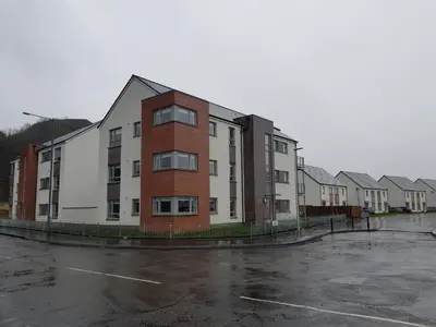 a row of apartment buildings in a parking lot at 11 Royal View Apartments in Stirling