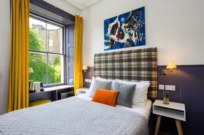 a bedroom with a bed and a window at New Town Guest House (Adults Only) in Edinburgh