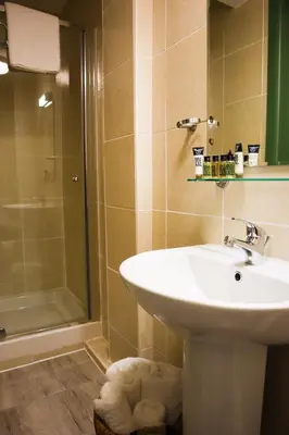 a bathroom with a sink and a shower at New Town Guest House (Adults Only) in Edinburgh