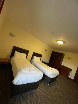 a hotel room with two beds in a room at Lochway Hotel in Dumbarton